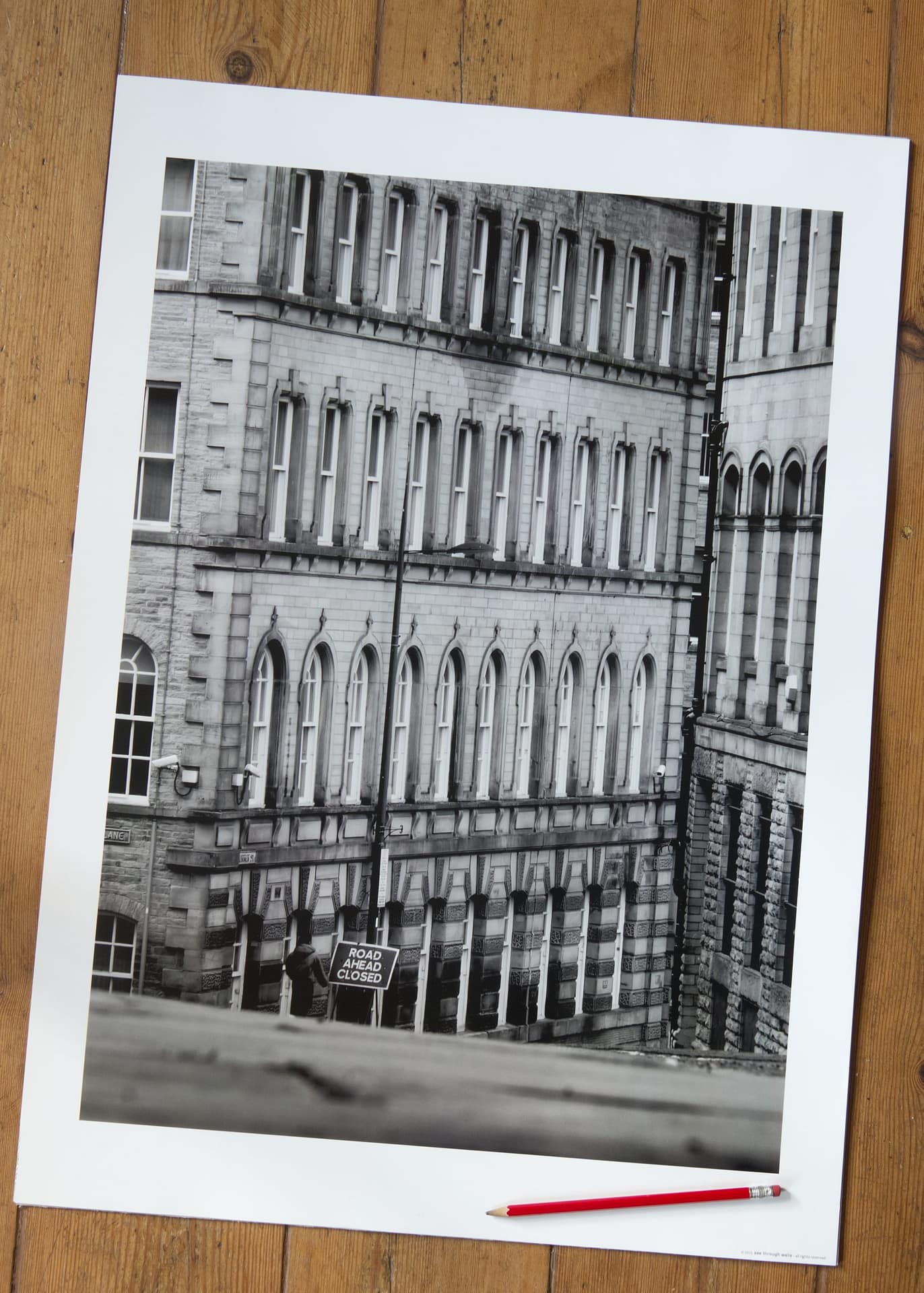 Road Ahead Closed Poster featuring towering historic city buildngs converging to create a narrow perspectice with a roiad sign indicating the Road is Closed.