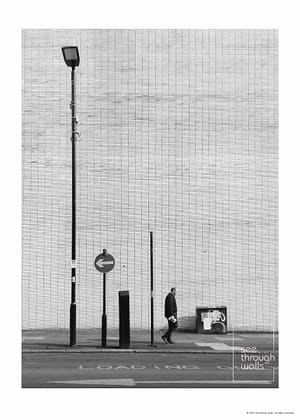 Man Walking Past a Minimalist City Wall