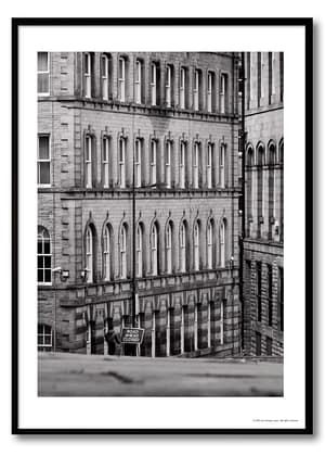 Black and white urban geometry photography print – Victorian arched façade with lone figure beside Road Ahead Closed sign at street level