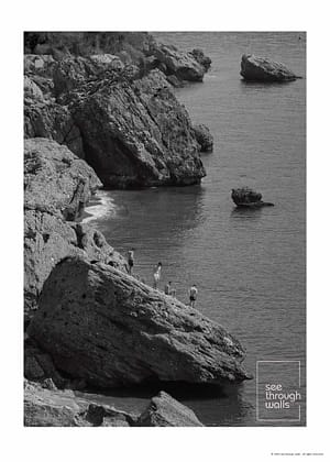 People Exploring Rocks by the Sea