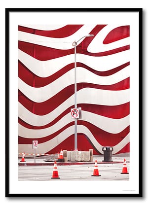 Los Angeles architecture photography print of the Petersen Museum's undulating red and white wave facade with traffic cones and no-entry signs in the foreground
