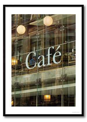 Urban glass cafe photography framed print showing layered Victorian façade reflection, solitary bearded figure, and globe pendant lights through modern glazing
