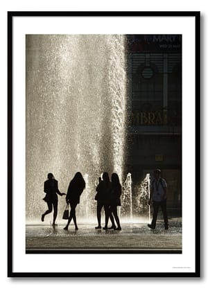 Fountain silhouettes photography print showing five school leavers backlit against cascading water with a city library in the background
