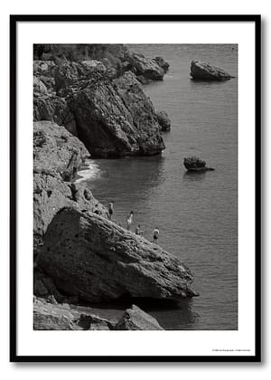Mediterranean coast photography print showing four figures on limestone rocks above a calm sea, monochrome coastal observation