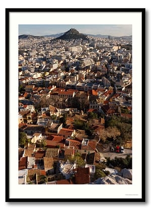 Athens cityscape photography print showing terracotta rooftops of Plaka with Lycabettus Hill and city sprawl beyond in warm morning light