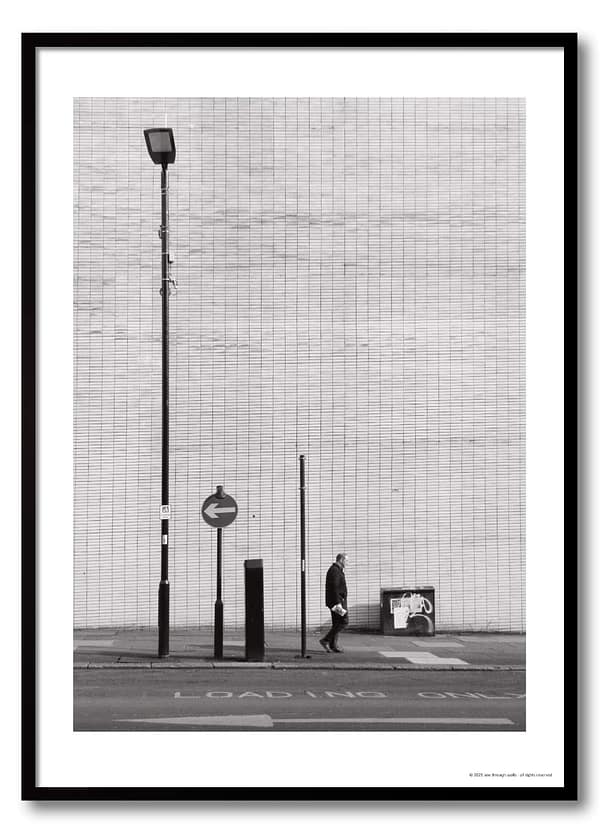 Sheffield urban photography print showing lone figure mid-stride against vast brutalist tiled wall with one-way arrow sign and lamp post