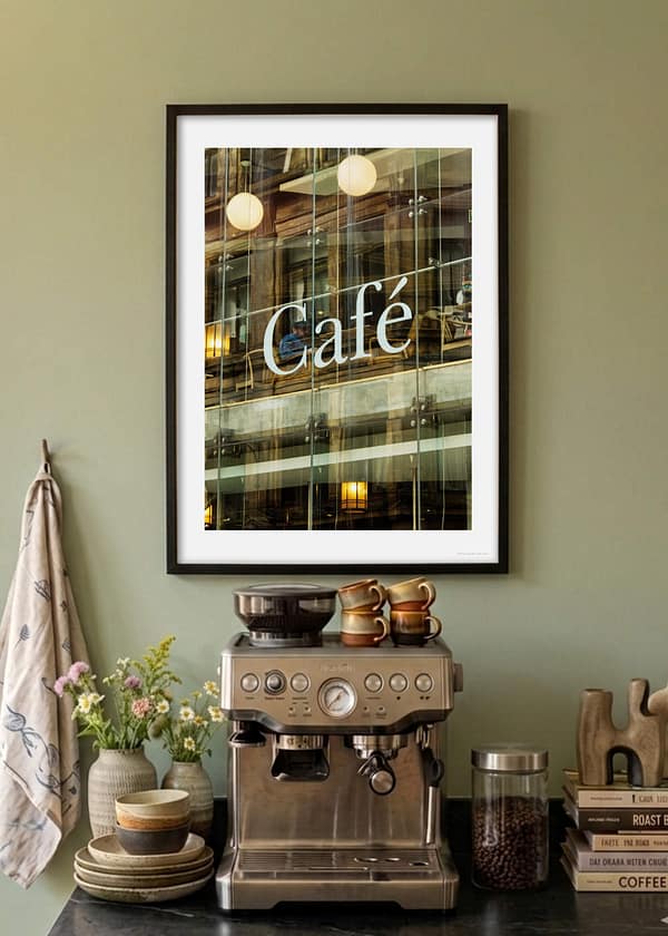 Kitchen coffee station with Urban glass cafe photography framed print showing layered Victorian façade reflection, solitary bearded figure, and globe pendant lights through modern glazing