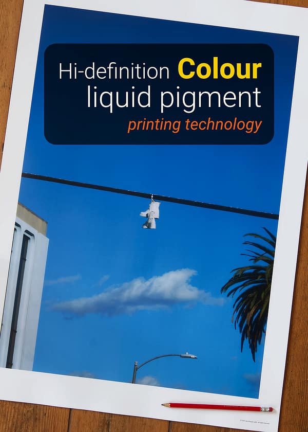 Los Angeles shoefiti photography print showing white boots hanging from a power line against a deep blue sky and palm tree.