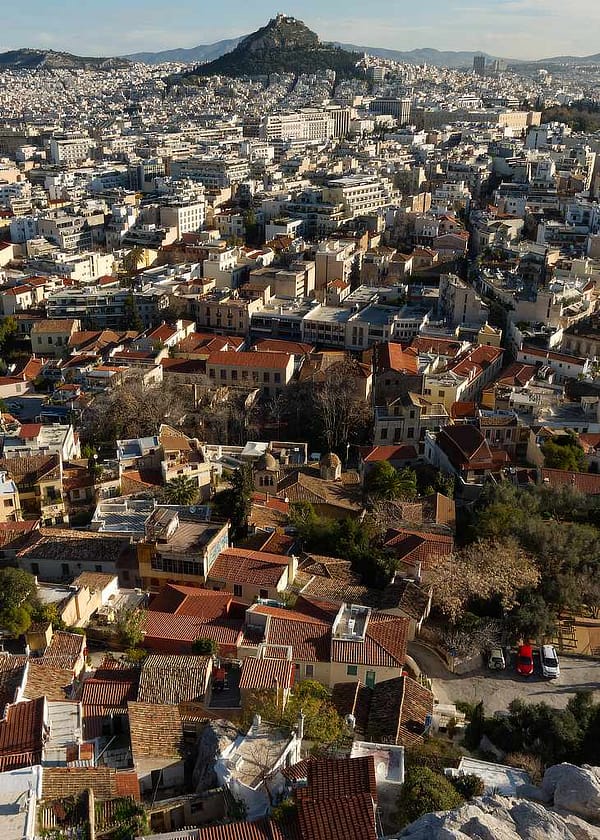 Artist-led photography print of Athens urban architecture in soft January morning light, featuring a cacophony of traditional pantile roofs and concrete structures on 250gsm heavyweight silken-touch media.